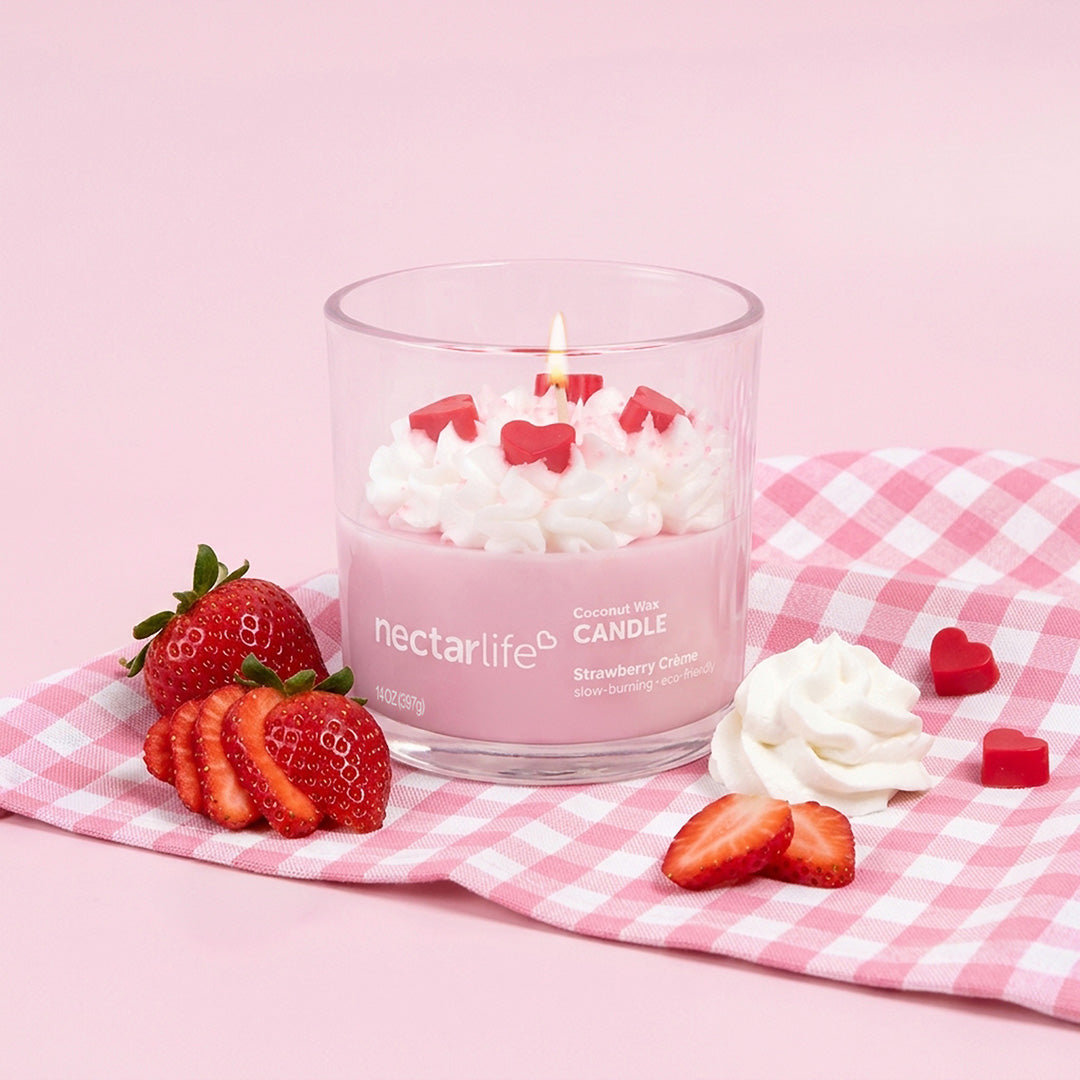 Strawberry Crème Coconut Wax Candle by Nectar Life lit and styled with fresh strawberries and whipped cream on a pink gingham background, 14oz
