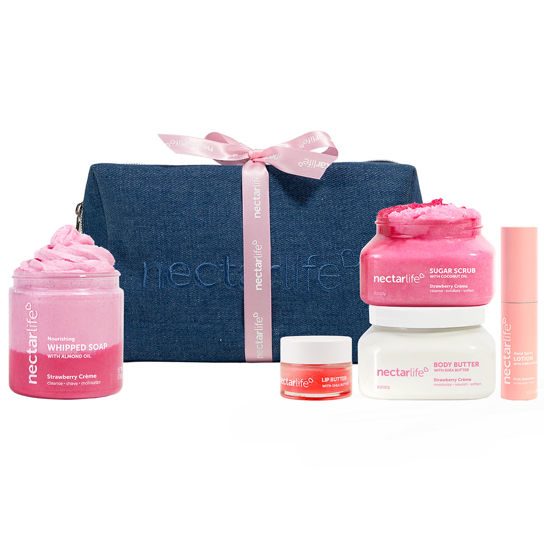 Strawberry Crème Denim Pouch gift set by Nectar Life with body butter, sugar scrub, whipped soap, hand spray lotion, lip butter, and dark denim travel pouch with pink ribbon