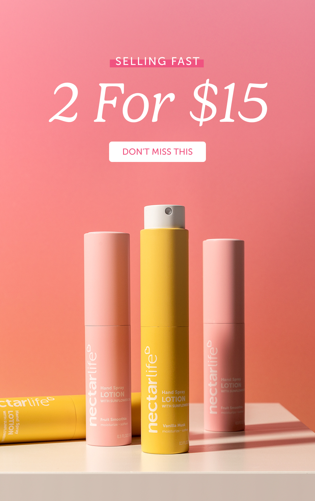 Four Nectar Life Hand Spray Lotion with Sunflower tubes in Fruit Smoothie and Vanilla Musk scents, displayed upright and laying flat against a pink background. Text reads: Selling Fast — 2 For $15.