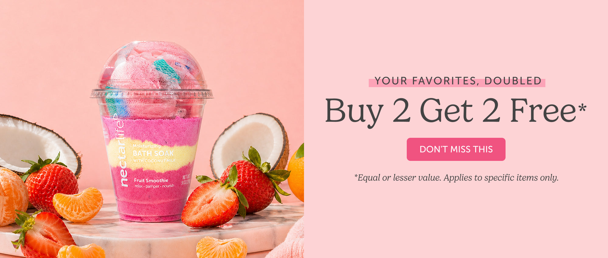 Nectar Life Fruit Smoothie Moisturizing Bath Soak with Coconut Milk in a smoothie cup surrounded by fresh strawberries, mandarin oranges, and coconut halves on a blush pink background. Text reads: Your Favorites, Doubled — Buy 2 Get 2 Free.