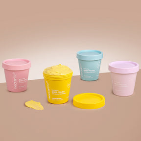 Nectar Life Body Polish all five scents, Lemon Squeeze Lavender Blossom Fruit Smoothie Ocean Breeze Peach Sangria, colorful tubs grouped on warm background, handmade in Las Vegas