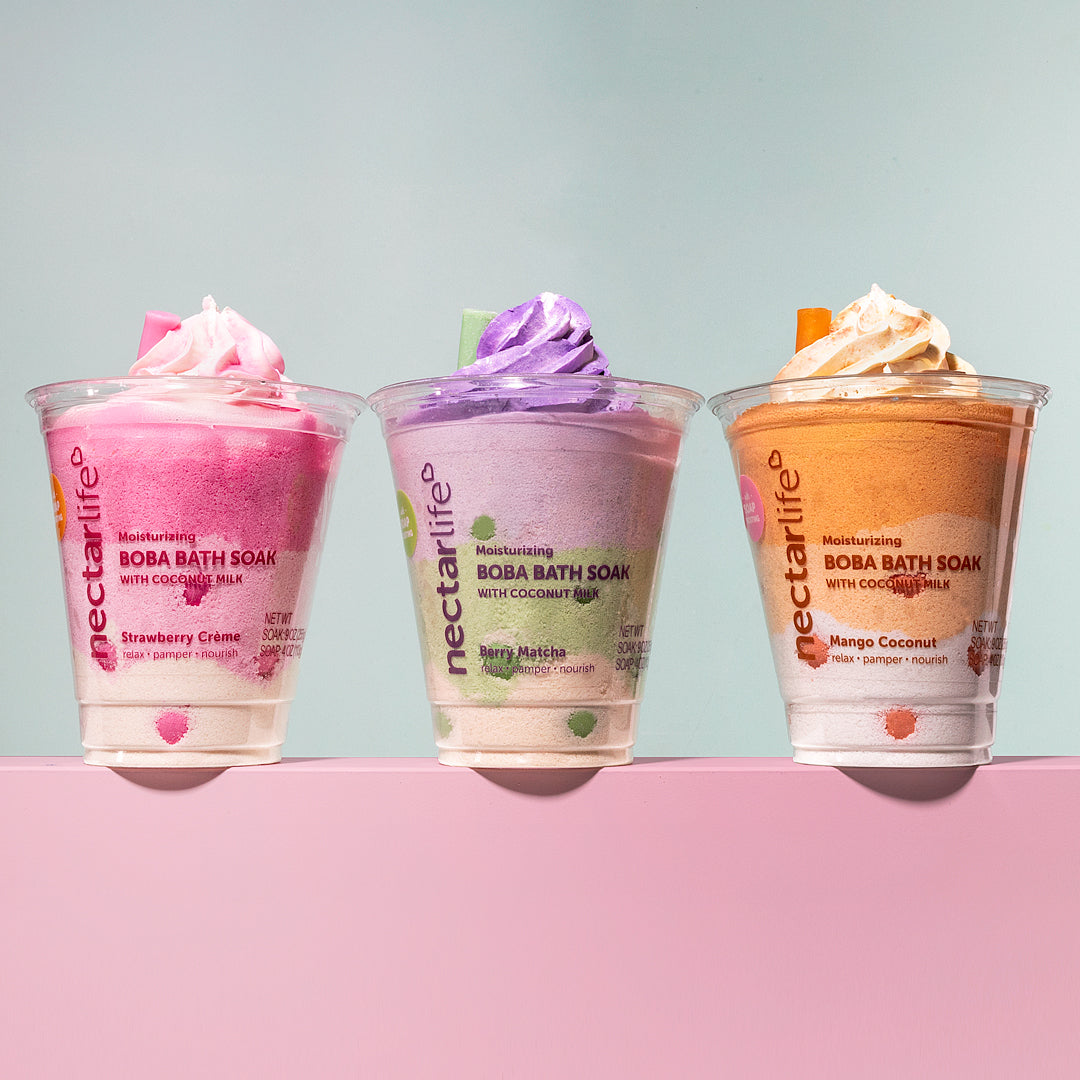 Three Nectar Life Boba Bath Soak cups in Strawberry Creme, Berry Matcha, and Mango Coconut