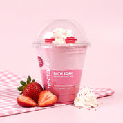 Strawberry Crème Milkshake Bath Soak by Nectar Life styled with fresh strawberries and whipped cream on a pink gingham background, 9oz