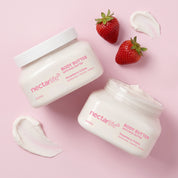 Two Nectar Life Strawberry Crème Shea Body Butter jars styled overhead on a pink background with fresh strawberries, 8oz, handmade in Las Vegas
