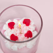 Strawberry Crème Coconut Wax Candle closeup overhead showing lit cotton wick, whipped wax topper, and heart embeds, soot-free and eco-friendly