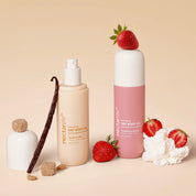 Nectar Life Nourishing Dry Body Oil in Vanilla Brûlée and Strawberry Crème, both 3.4 fl oz bottles styled with vanilla bean, brown sugar, fresh strawberries, and whipped cream on a warm neutral background