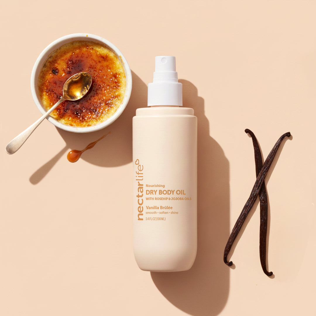 Vanilla Brûlée Dry Body Oil by Nectar Life next to creme brulee and vanilla beans, lightweight dry oil with rosehip and olive squalane, 3.4 fl oz