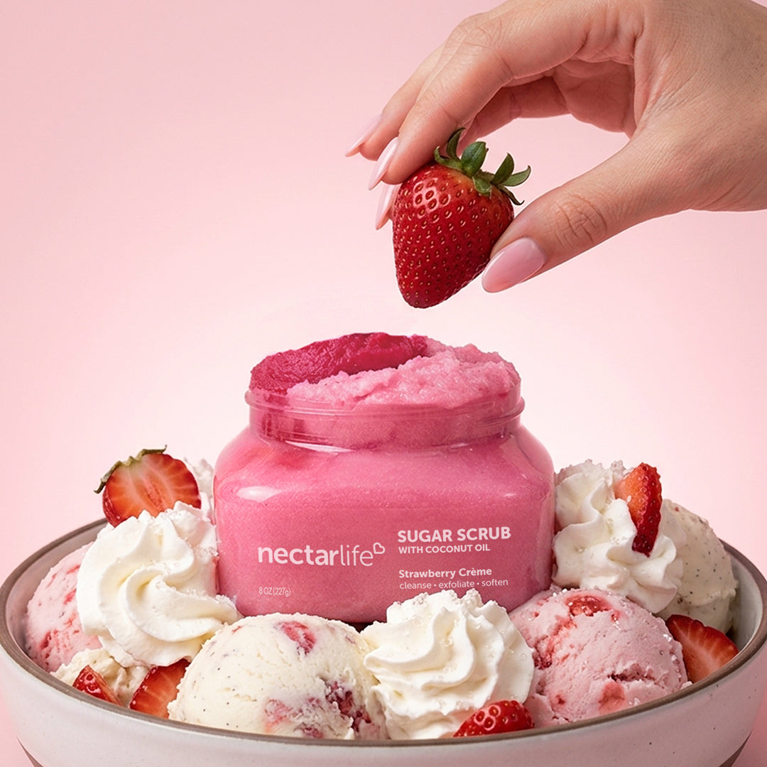 Nectar Life Strawberry Crème Sugar Body Scrub jar styled in a bowl of ice cream scoops with fresh strawberries, 8oz, handmade in Las Vegas