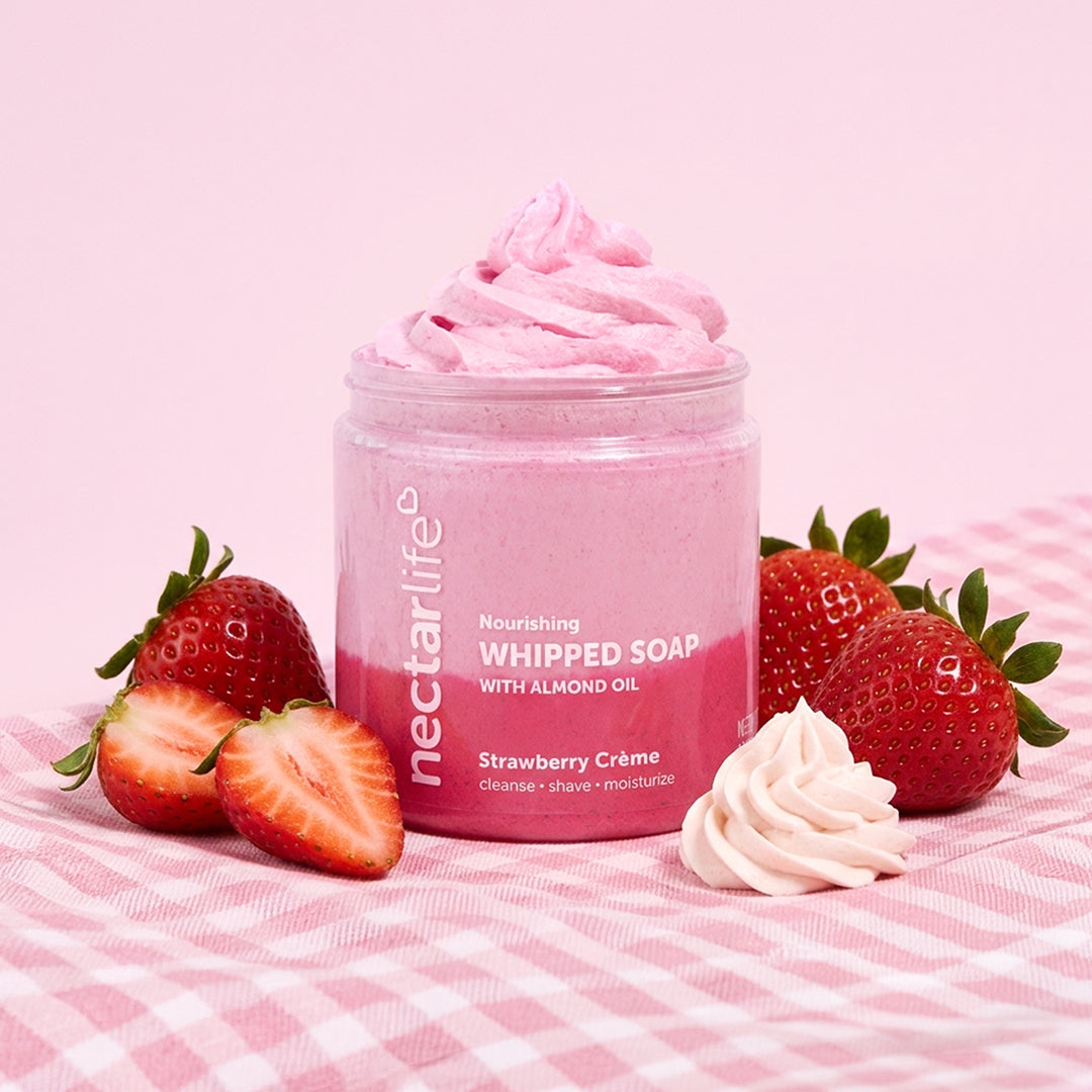 Strawberry Crème Whipped Soap jar by Nectar Life styled with fresh strawberries and whipped cream on a pink gingham background, 5oz