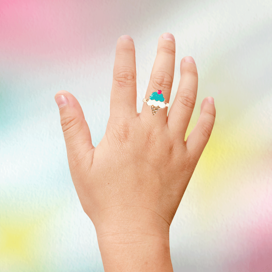 Child's hand wearing a colorful heart ring from a Nectar Life Surprise Ring Bath Bomb, one of 15 surprise designs included inside each bomb