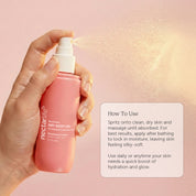 Hand spraying Nectar Life Strawberry Crème Dry Body Oil onto skin, fast-absorbing formula with rosehip oil and olive squalane, 3.4 fl oz