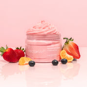 Nectar Life Fruit Smoothie Nourishing Whipped Soap and Shave Butter 10oz jar with whipped pink soap piled high, surrounded by fresh strawberries, blueberry, and mandarin orange segments on a soft pink background