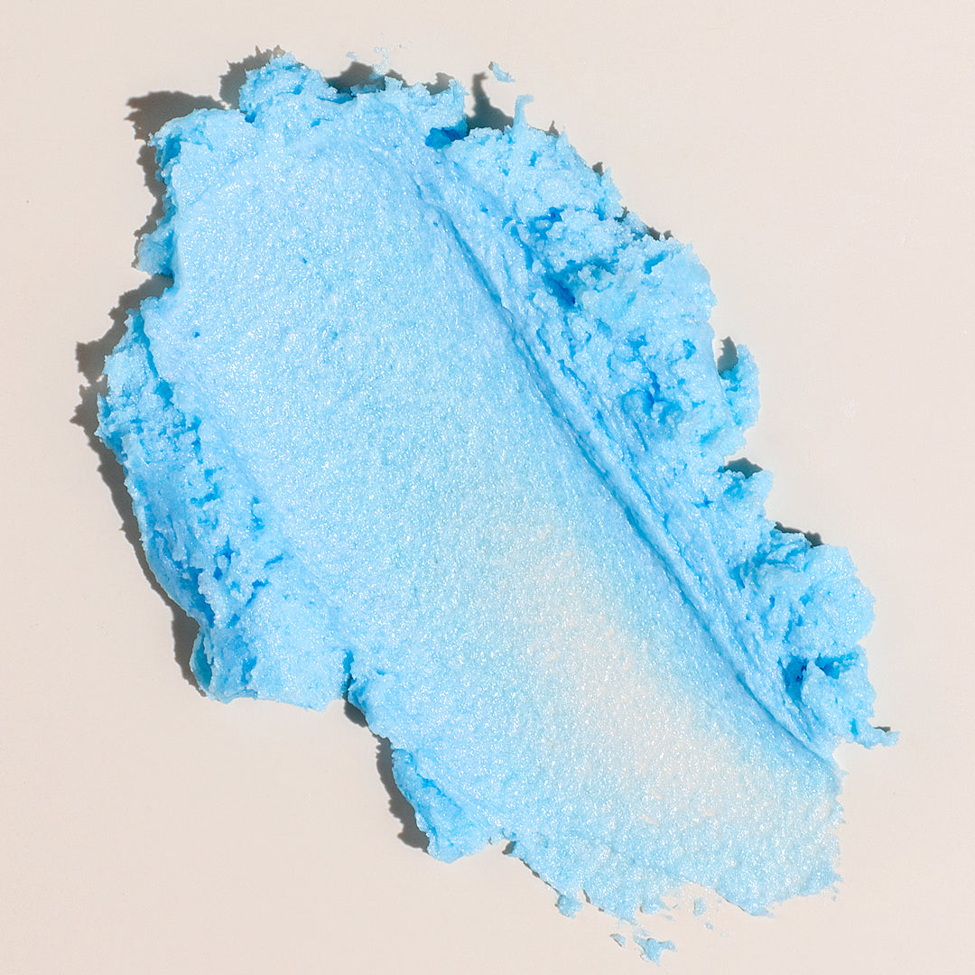 Close up texture swatch of Nectar Life Ocean Breeze Whipped Soap showing light blue shimmer and creamy consistency on a neutral background
